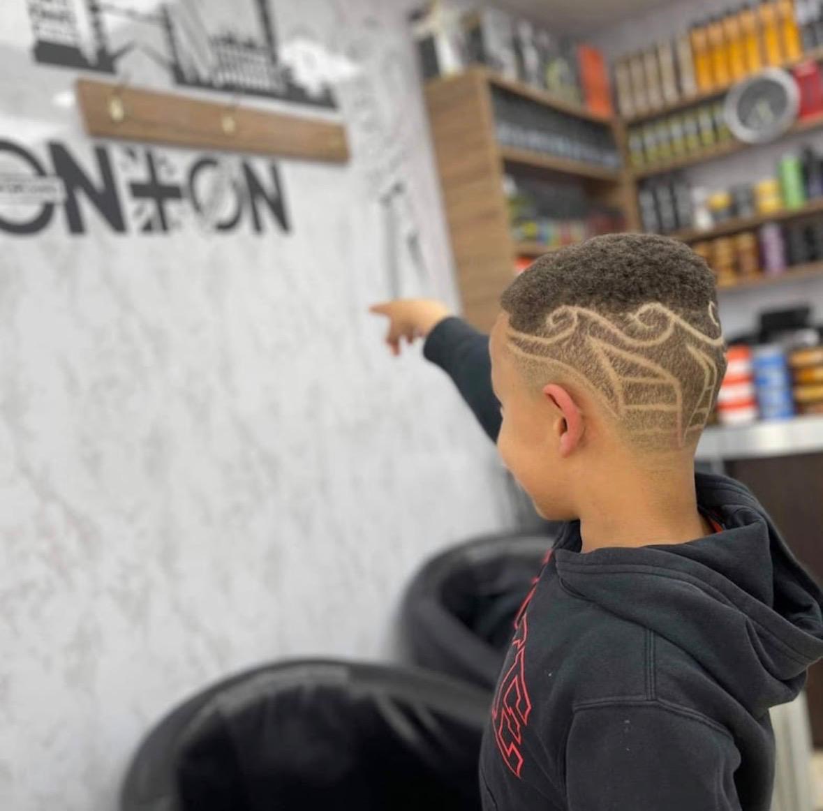 Sharp hair design and high skin fade on a young customer