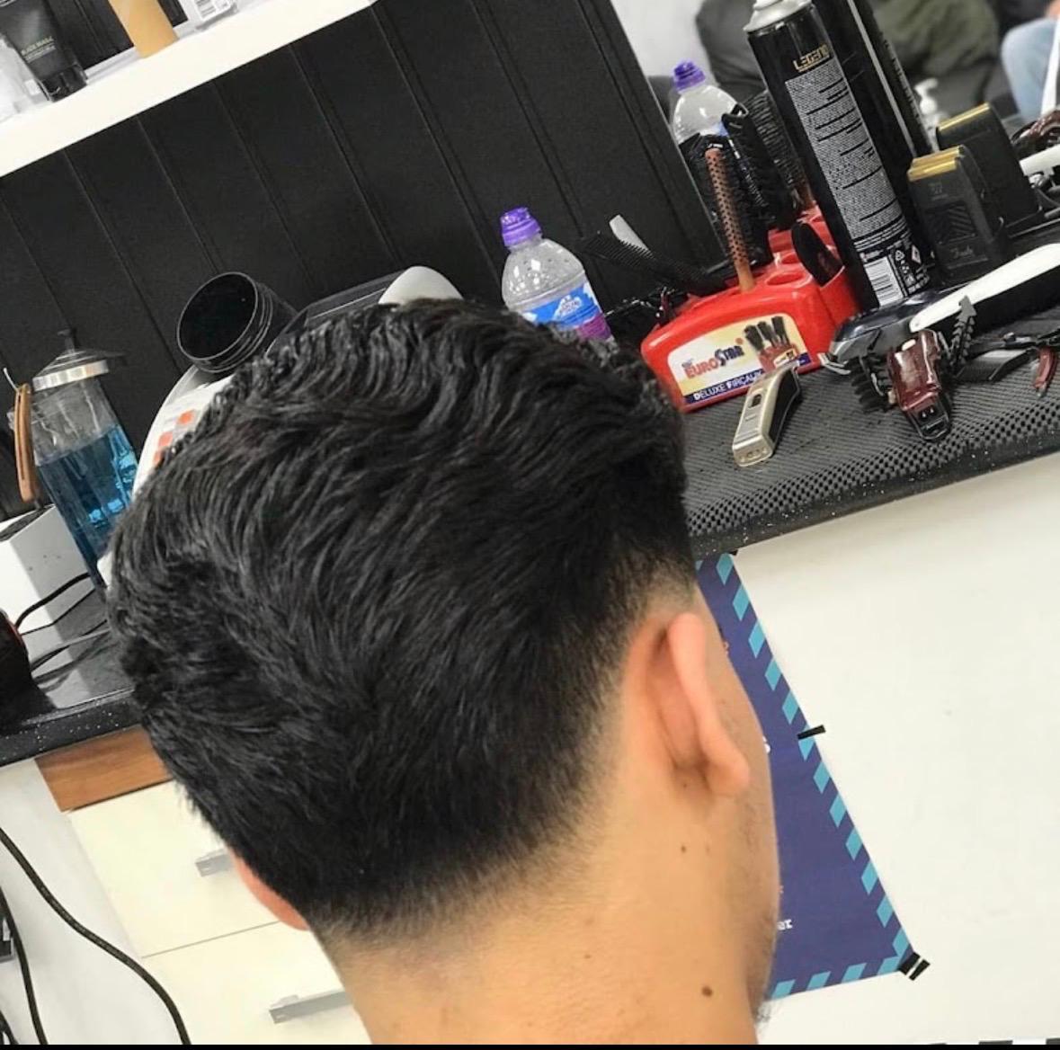 Textured crop with a low fade finished in the barbershop